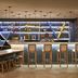Novotel Campo Grande bar and lounge with illuminated shelves, high stools, and seating area in Campo Grande