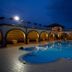 La Vecchia Torre in San Nicola Manfredi with illuminated outdoor pool and arched courtyard at night