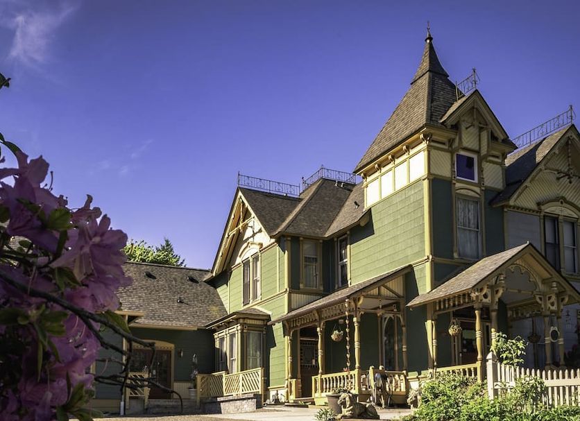 Swantown Inn & Spa in Olympia, Victorian-style inn exterior with porch and purple flowers