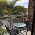 Logan City Motor Inn in Slacks Creek balcony with table, chairs and tropical palm view