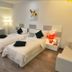 Hotel Vijay Parkinn, Gandhipuram, Coimbatore twin room with two beds, bedside lamps and a sofa
