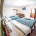 Eco Home View Guest House Cusco room with two beds, wooden floor and balcony door