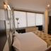 Kosk Sivas hotel room in Sivas with double bed, TV, desk and large window blinds