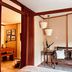 Boutique Hotel Casa Teatro Manaus room with wooden bench seating and hanging pendant lights