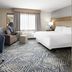 Candlewood Suites Williamsport guest room with king bed, sofa, desk, and large window