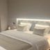 Estalagem Vianorte in Matosinhos: modern hotel room with a neatly made bed and soft headboard lighting