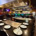 Wingate by Wyndham Sheboygan buffet dining area with table settings and a large kitchen hood