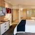 First Group Riviera Suites in Cape Town guest room with king bed, TV, and bathroom view