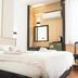 Hotel Guleryuz in Antalya guest room with double bed, wall mirror, and compact seating area