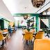 Novotel Melbourne Glen Waverley restaurant with mustard velvet chairs and modern green accents
