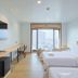 The Royal City Hotel Bangkok room with twin beds and city view through large windows
