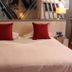 La Confiance, Le Mont-Saint-Michel: double bed with red pillows, bedside lamps and mirror headboard