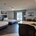 Independence Stay Hotel and Long term suites in Houghton guest room with two beds, window view and kitchenette