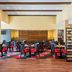 Four Points by Sheraton Buffalo Grove dining room with red-accented chairs and wood ceiling beams