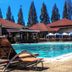 Hotel Sibayak International in Berastagi: outdoor pool with lounge chair and red-roofed buildings