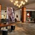 Lobby at Renaissance Boulder Flatiron Hotel in Broomfield with chandelier, horse wall art and long communal table