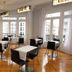 El Rincón de Gran Vía in Madrid lounge with tables, chairs and tall windows overlooking the street