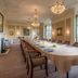 Danesfield House Hotel And Spa in Marlow: elegant boardroom dining table with chandeliers and garden view