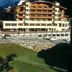 Pension Berggeist in Sölden with alpine hotel buildings beside a road and grassy hillside