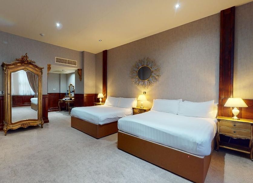 The Coal Exchange Hotel Cardiff room with two beds, ornate mirror, and bathroom view