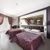 Ideal Pearl Hotel Adults Only in Marmaris: twin beds, mirror wall, window with drapes, and TV