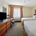 La Quinta Inn & Suites by Wyndham Sawgrass in Sunrise guest room with two double beds and desk