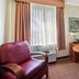La Quinta Inn & Suites by Wyndham Sawgrass Sunrise room with desk, chair and window
