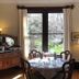 Beaufort House Inn Asheville dining room with round table, antique sideboard and large window