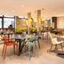 ibis Paris Alésia Montparnasse 14ème dining area in Paris with colorful chairs and tables