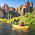 Saguaro Lake Ranch in Mesa with kayakers on calm water beneath rugged desert cliffs