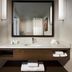 Hilton Garden Inn Montreal Airport bathroom vanity with mirror, sink, and folded towels