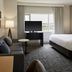 Residence Inn by Marriott Montreal Airport guest room with sofa, TV, bed, and window view in Montreal