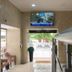 Residencial Lar do Areeiro in Lisbon lobby with entrance doors, seating area and TV mounted above.