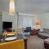 Residence Inn by Marriott Knoxville Cedar Bluff living area with sofa, desk, dining table and TV
