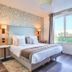 Séjours & Affaires Paris-Vitry room with king bed, floral accent wall, and large window in Vitry-sur-Seine