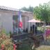 La Garona in Saint-Nicolas-de-la-Grave: garden patio with pink umbrellas, chairs and picnic tables