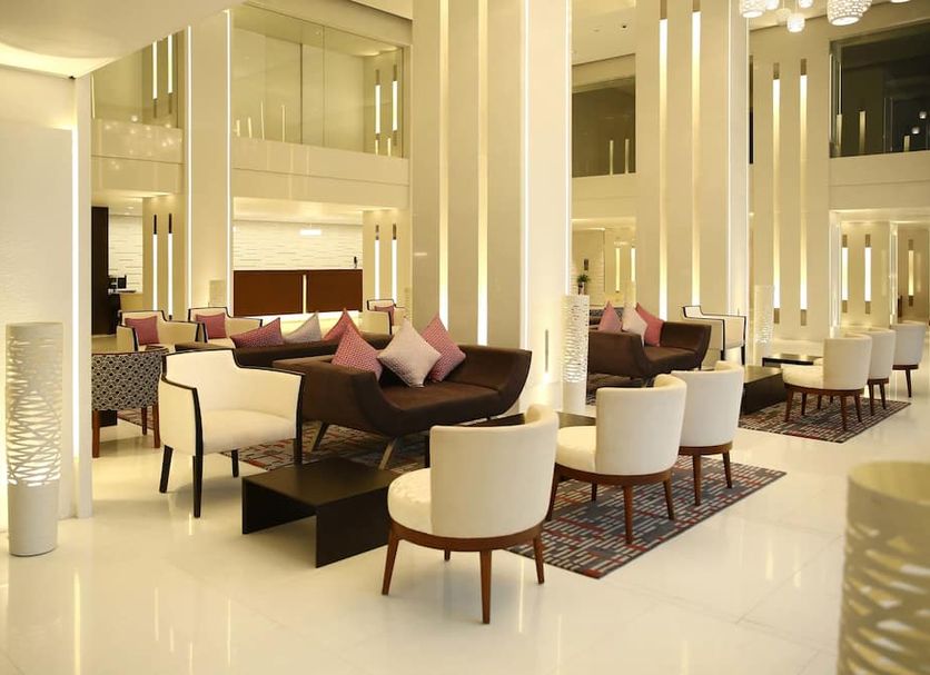 Ramada by Wyndham Colombo lounge with modern seating and tall mirrored columns in Colombo