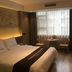 Anyi 158 Hotel Renming Park room in Chengdu with bed, window seating and TV