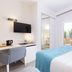 Invisa Hotel Es Pla - Adults Only room in Sant Antoni de Portmany with bed, desk and balcony doors