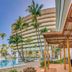 Melia Habana in Havana with palm-lined pool, loungers and curved tower under a blue sky
