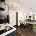 Sonesta Simply Suites Pittsburgh Airport suite with full kitchen, dining table, sofa, and separate bedroom