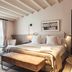 Sant Francesc Hotel Singular guest room in Palma de Mallorca with king bed, seating area, and sheer curtains