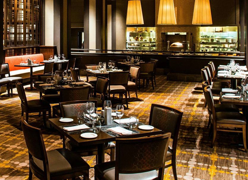 The Westin Rancho Mirage Golf Resort & Spa dining room with hanging pendant lamps and set tables