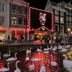 Hotel Royal Taste in Amsterdam at night with swans on a canal beside lit shopfronts
