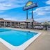 Days Inn by Wyndham Jacksonville NC outdoor pool with motel exterior and sign in Jacksonville
