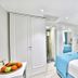 Glamour Hotel Istanbul Sirkeci room with twin beds, white wardrobe, and a view into a mirrored bathroom
