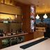 Bar area at Hampton By Hilton Derby City Centre in Derby with hanging lights and beverage display