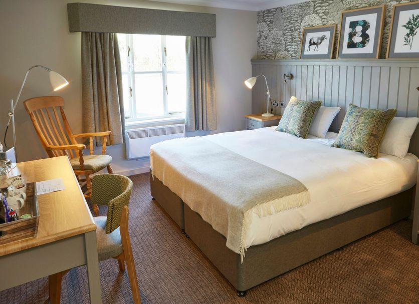 The Bluebird Inn at Samlesbury room in Blackburn with king bed, window, and seated desk area