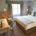 The Bluebird Inn at Samlesbury room in Blackburn with king bed, window, and seated desk area