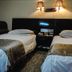 Orange Crystal Hotel Xuzhou Suning Plaza guest room with twin beds and wall sconces in Xuzhou